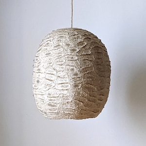 Light beige paper pulp lamp with horizontal clearances in the shell.  Wege. Model 27.