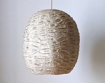 Light beige paper pulp lamp with horizontal clearances in the shell.  Wege. Model 27.