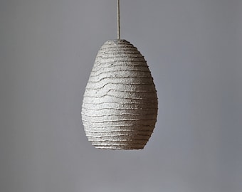 Lamp made of a transparent layer of paper mache. Irregular oval shape. Natural materials. Vegan. Model 23