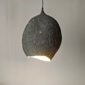 Suspension papier maché lamp. Gray paper pulp. The irregular oval of the lampshade resembles a drop or lump of concrete.  Model 20.