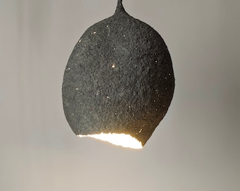 Suspension papier maché lamp. Gray paper pulp. The irregular oval of the lampshade resembles a drop or lump of concrete.  Model 20.