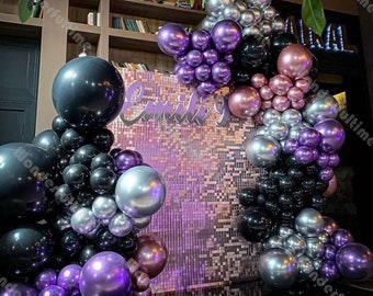 May include: A purple, silver, black and rose gold balloon arch with the name "Emily 9" on a sparkly purple backdrop.
