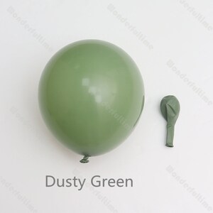 May include: Two dusty green latex balloons, one inflated and one deflated. The inflated balloon is large and round, while the deflated balloon is smaller and elongated. The text "Dusty Green" is written below the balloons.