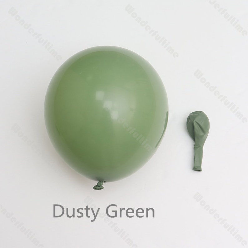 May include: Two dusty green latex balloons, one inflated and one deflated. The inflated balloon is large and round, while the deflated balloon is smaller and elongated. The text "Dusty Green" is written below the balloons.