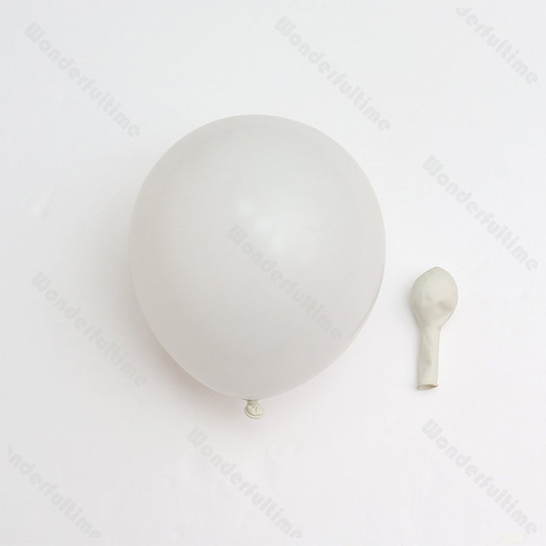 May include: A white balloon and a deflated white balloon.