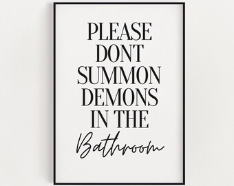 May include: A framed art print with a black frame and a white background. The print features black text that reads "PLEASE DON'T SUMMON DEMONS IN THE Bathroom."