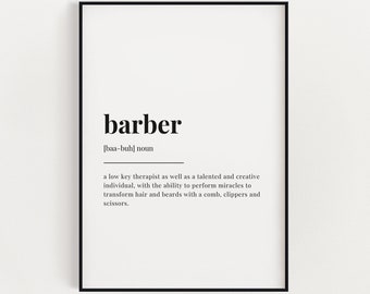 May include: A framed print with the definition of "barber" in black text on a white background. The definition includes the pronunciation and a description of a barber's skills, such as transforming hair and beards.