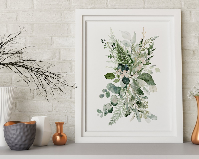 May include: A white framed print featuring a watercolour painting of a bouquet of green leaves and white flowers.
