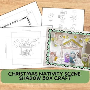 May include: A Christmas Nativity Scene Shadow Box Craft kit. The image shows a completed shadow box with a green scalloped border, and several sheets of paper with line drawings of the Nativity scene, including Mary, Joseph, and baby Jesus.