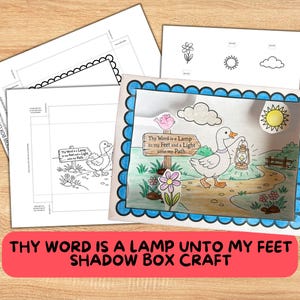May include: A colorful shadow box craft featuring a duck carrying a lantern on a path, with the text "Thy Word is a Lamp to my Feet and a Light unto my Path." Includes additional cut-out elements and instructions.