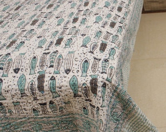 May include: A white kantha quilt featuring a blue and brown fish pattern. The quilt has a decorative border with a paisley design.