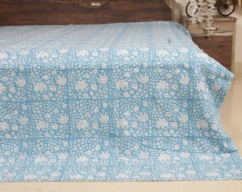 May include: A light blue quilt with a white floral pattern. The quilt is made of a soft material and is likely used for bedding. The floral design is evenly distributed across the surface, creating a visually appealing textile.
