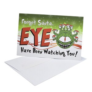 May include: A Christmas card with a green monster with multiple eyes wearing Santa hats. The card says "Forget Santa, EYE Have Been Watching You!"