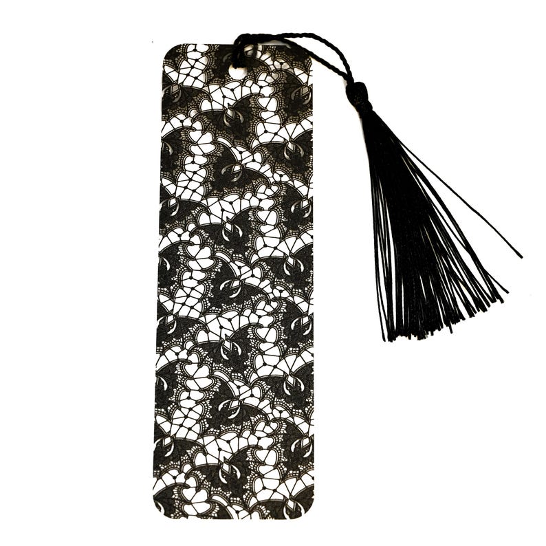 May include: Black and white lace bookmark with a black tassel.