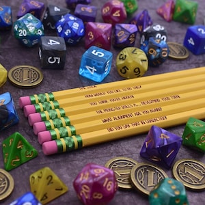 May include: A set of yellow pencils with pink erasers and green metal ferrules, each featuring unique text including "HOW WOULD YOU LIKE TO DO THIS?" and "DID YOU SAY THAT IN CHARACTER?", surrounded by various multi-sided gaming dice and coins.
