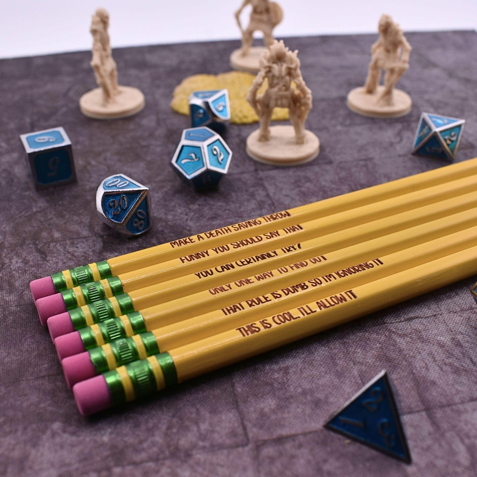 6 yellow pencils with different DnD related settings, a variety of differently shaped dice, and four figurines are all positioned on a dark purple grid map.