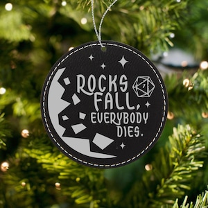 May include: Black leather Christmas ornament with white text that reads "Rocks Fall, Everybody Dies."  A white dice with a 7 on it is also on the ornament.