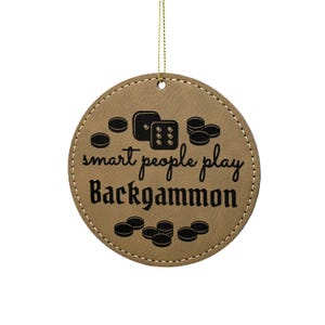 May include: A brown leather ornament with the text "smart people play backgammon" and a black illustration of dice and game pieces.