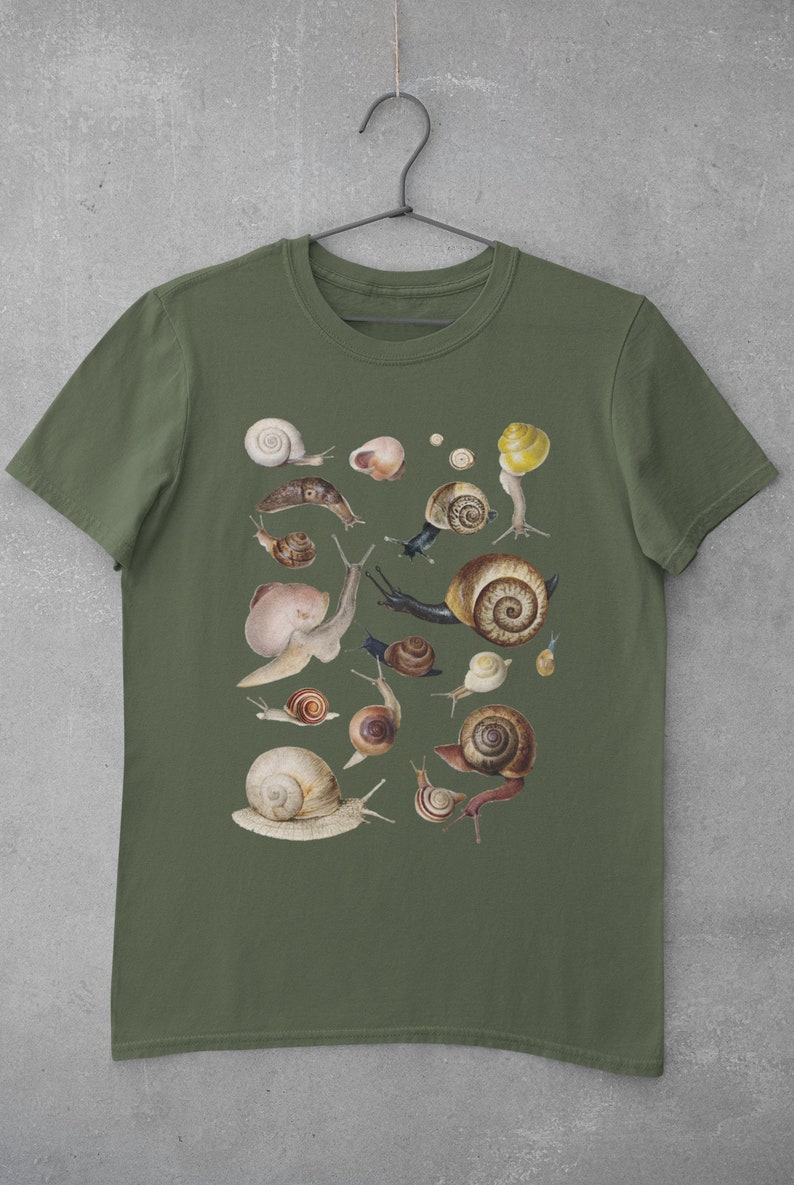 May include: A green t-shirt with a print of various snails in different sizes and colors. The snails are arranged in a random pattern on the shirt.