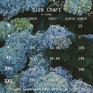 May include: Size chart for clothing in inches. The chart shows sizes S through 3XL with corresponding measurements for length, chest, and sleeve length.