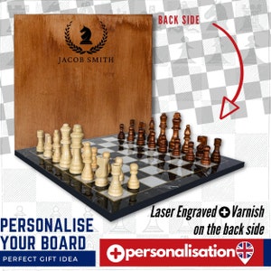 May include: Personalized wooden chessboard with black and white squares and a marble-like design. The board comes with a set of wooden chess pieces. The back of the board can be personalized with a laser engraved design and a varnish finish. The image shows a chessboard with the name "JACOB SMITH" engraved on the back.