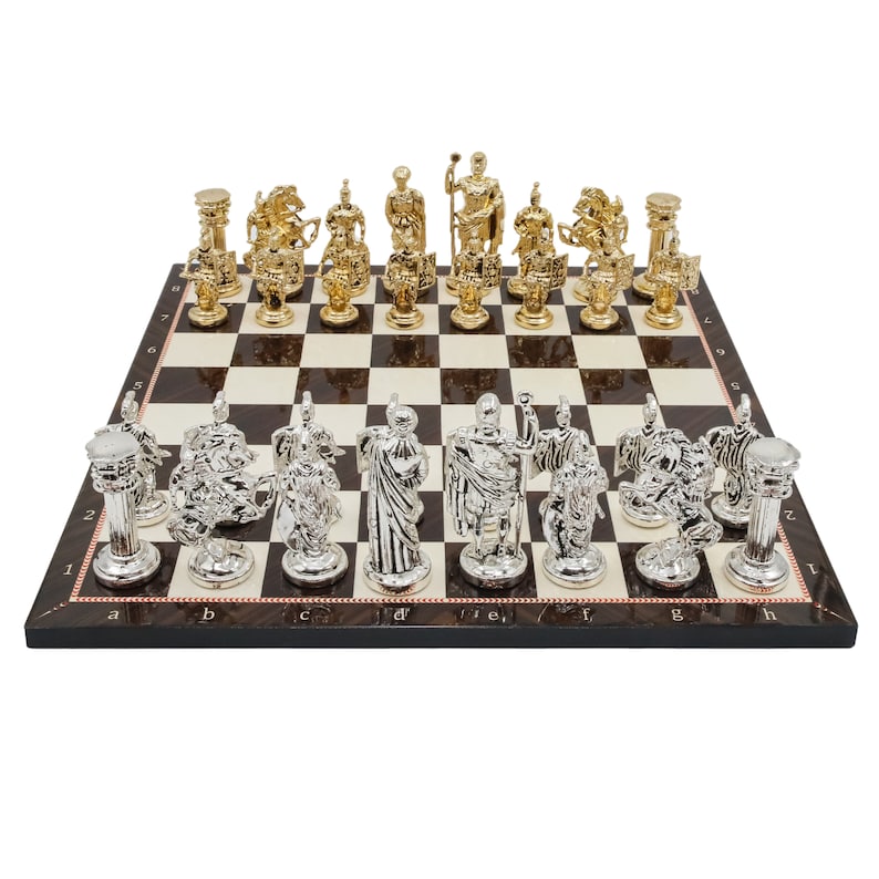 Op de afbeelding: Een schaakset met gouden en zilveren stukken op een houten bord. De stukken zijn in de vorm van Romeinse soldaten en andere figuren. Het bord heeft een zwart-wit geblokt patroon.