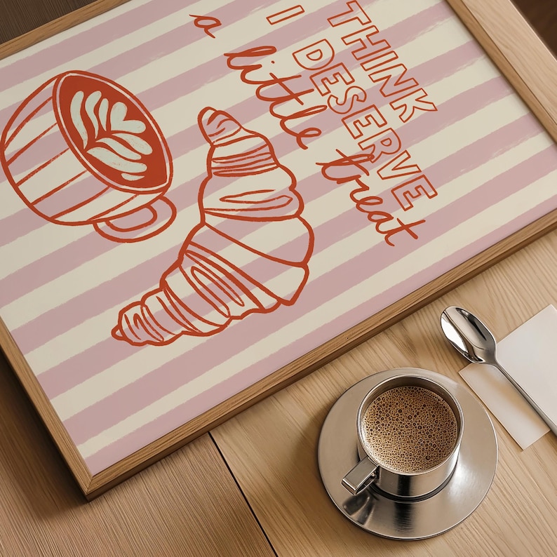 Framed coffee print resting near books and a warm coffee mug, ideal for a cozy aesthetic.