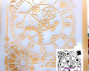 May include: A translucent plastic stencil sheet featuring a clock face design with Roman numerals, intricate internal gears, and mechanical components. The text "TIME MACHINE" is printed along the top arc of the clock. A small circular tag reads "Hand made".