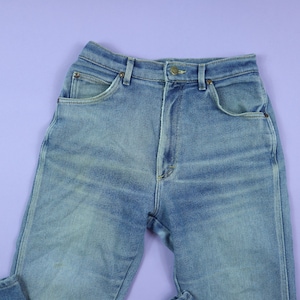 May include: A pair of light blue denim jeans with a classic five-pocket style. The jeans have a high waist and a straight leg.