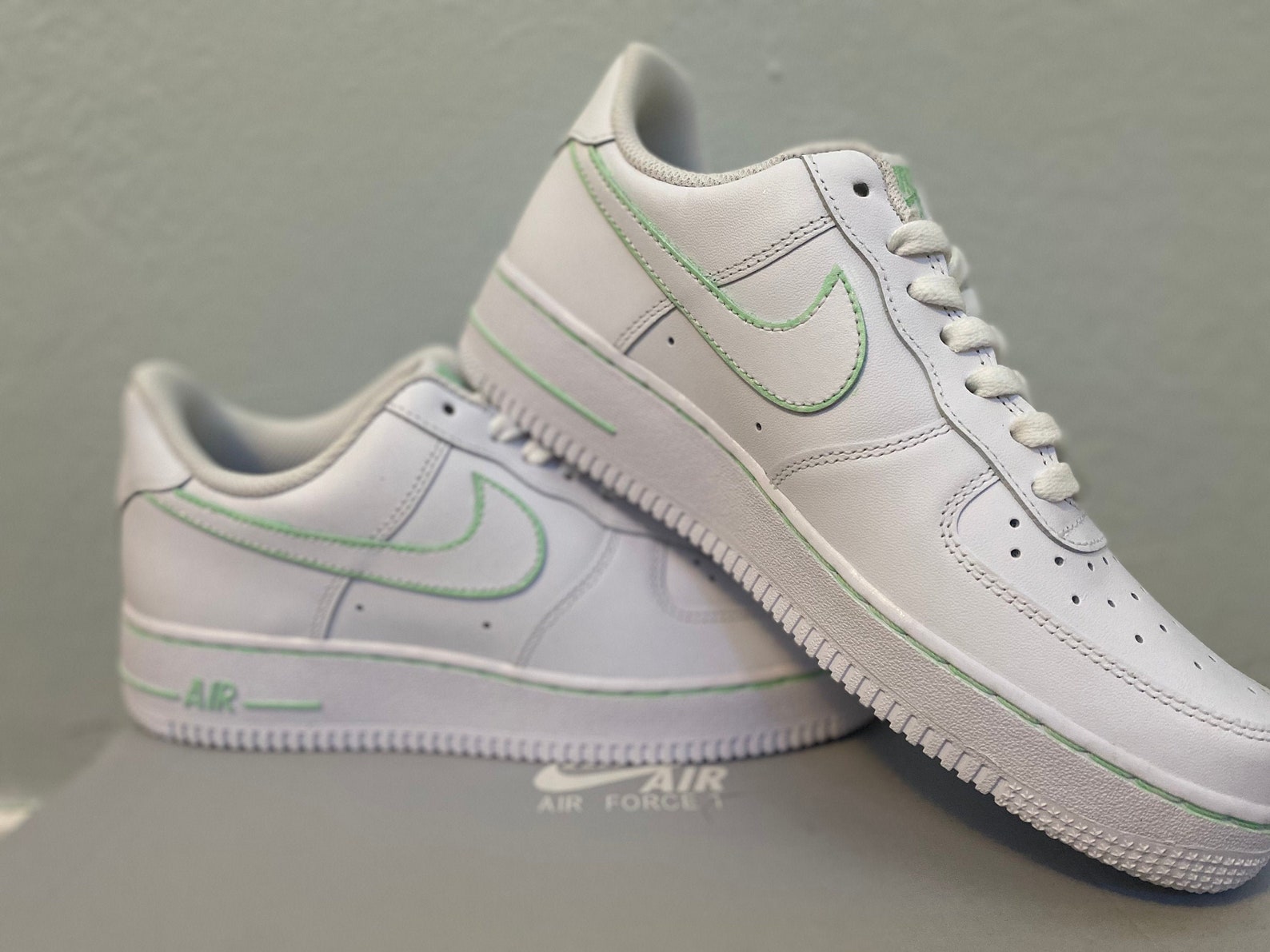 white air forces with gold outline