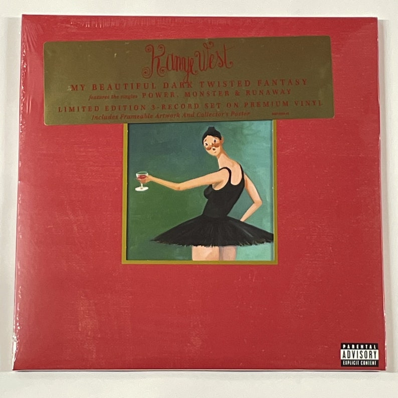 May include: Sealed vinyl record album with a red cover. The album is titled "My Beautiful Dark Twisted Fantasy" by Kanye West. The cover art features a painting of a woman in a black dress holding a glass of wine. Includes a parental advisory warning.