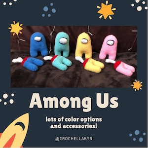 May include: Four crocheted Among Us characters in blue, turquoise, yellow, and pink. The characters are lying on a brown surface. The text "Among Us" is written in white letters on a dark blue background. The text "lots of color options and accessories!" is written in white letters on a dark blue background. The text "@CROCHELLABYN" is written in white letters on a dark blue background.
