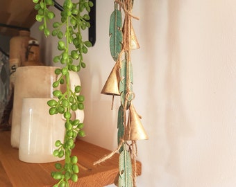 Hanging windchime with cow bells on a string with green patina brass feather pendants, witch bells, rustic vintage door hanger, suncatcher