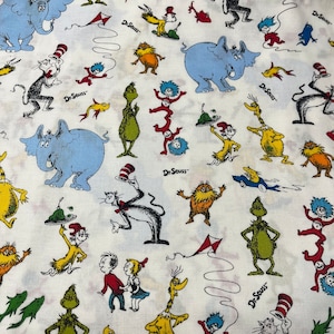 May include: White fabric with a repeating pattern of Dr. Seuss characters, including the Cat in the Hat, Thing 1 and Thing 2, the Grinch, and the Lorax. The fabric is printed with the text "Dr. Seuss" multiple times.