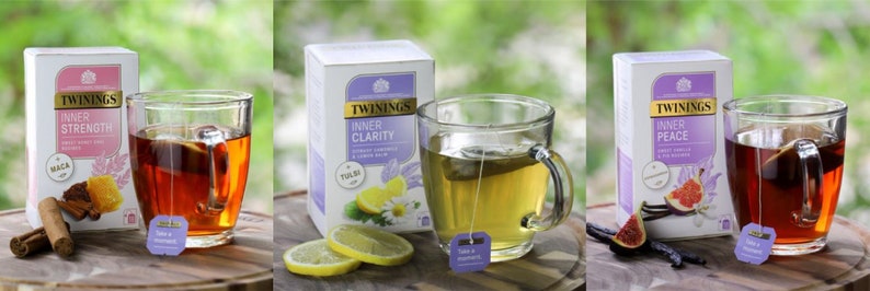 May include: Three boxes of Twinings Inner Strength, Inner Clarity, and Inner Peace herbal tea. Each box features a different blend of herbs and spices, including cinnamon, honey, lemon, chamomile, fig, and vanilla. The boxes are displayed on a wooden surface with a cup of tea in front of each box.