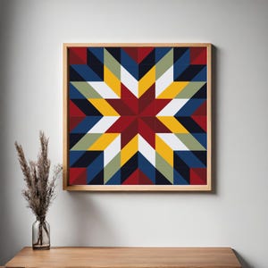 May include: A framed artwork featuring a geometric starburst design. The starburst is composed of various colored triangles, including red, yellow, blue, white, and black. The artwork is encased in a light-colored wooden frame, suitable for wall decor.