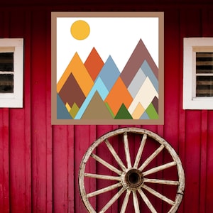 May include: A geometric abstract art print of a mountain range with a yellow sun in the top left corner. The mountains are in shades of brown, orange, blue, green, and yellow.