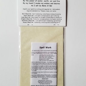 Pu&ograve; includere: Un pacchetto di carta bianca con uno sfondo beige. Il pacchetto contiene un foglio di carta pergamena con istruzioni per il lavoro magico. Il testo sul pacchetto recita "Con il potere dell'acqua, della terra, dell'aria e del fuoco Con la mia mano invoco i miei desideri e le mie aspirazioni Come voglio, cos&igrave; sia" e elenca diversi tipi di inchiostro magico e i loro usi. Il testo sulla carta pergamena recita "Lavoro Magico" e include istruzioni per eseguire gli incantesimi.