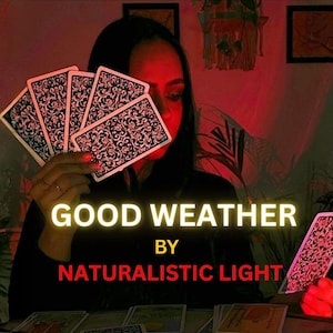 May include: A set of tarot cards with intricate black and white floral patterns on the back. The text GOOD WEATHER BY NATURALISTIC LIGHT is displayed in the center. Several cards are held in a fan shape, with one card placed separately.