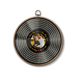 May include: A circular wall hanging featuring a black vinyl record design framed in wood. The center displays a photograph of a couple, the text The First Time Ever I Saw Your Face, Janice & Selwyn, and May 30, 1976, with lyrics circling the edge.