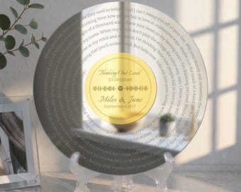 May include: A circular silver-toned plaque featuring lyrics from the song Thinking Out Loud by Ed Sheeran engraved around the edge. The center has a gold circular label with the song title, artist name, a Spotify code, and the names Miles & June.