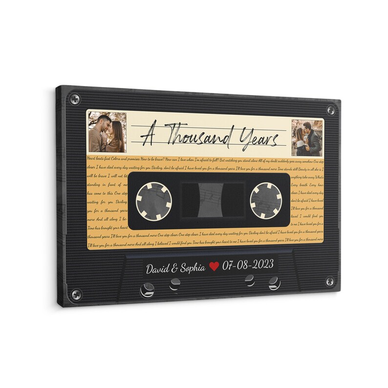May include: A black cassette tape with a vintage design. The tape has a label with the text "A Thousand Years" and a photo of a couple. The label also includes the text "David & Sophia" and the date "07-08-2023".