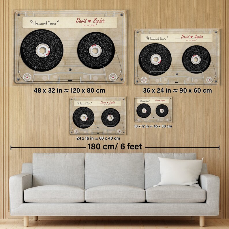 May include: Four framed cassette tape art pieces with the text "A Thousand Years" and names "David & Sophia" with a date. The largest is 48 x 32 inches, the smallest is 18 x 12 inches. The art is displayed above a gray sofa.