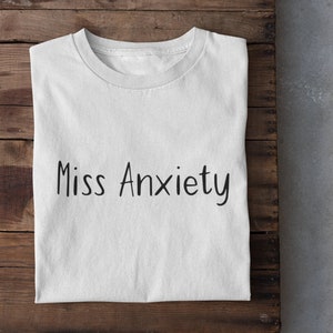Miss Anxiety Women's Simple Text T-Shirt | Funny Anxious Graphic Tee | Cute Anxiety Shirt | Relatable Mental Health Top | Comfortable Wear