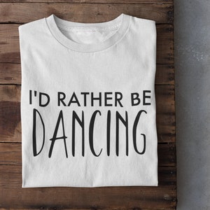 May include: White t-shirt with black text that reads "I'd rather be dancing".