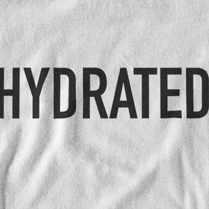 May include: White t-shirt with the word "HYDRATED" printed in black.