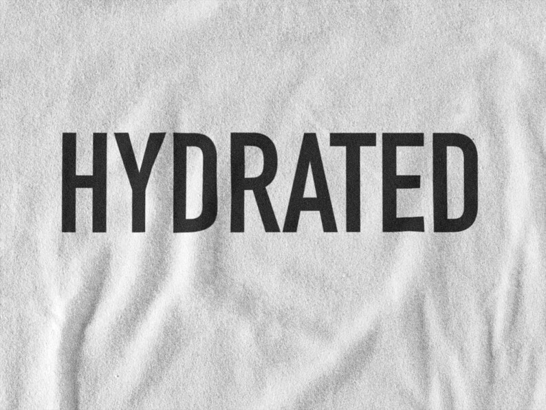 May include: White t-shirt with the word "HYDRATED" printed in black.