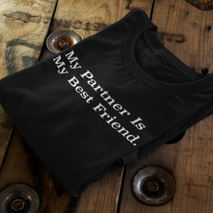 May include: Black t-shirt with white text that reads "My Partner is My Best Friend."