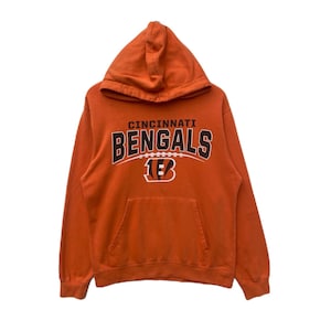 May include: Orange hooded sweatshirt with the text "Cincinnati Bengals" and a football graphic in black and brown.