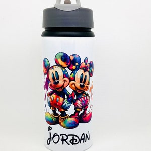 May include: White water bottle with a black lid and a handle. The bottle features a colourful image of Mickey Mouse and Minnie Mouse holding hands. The name "JORDAN" is printed on the bottle.